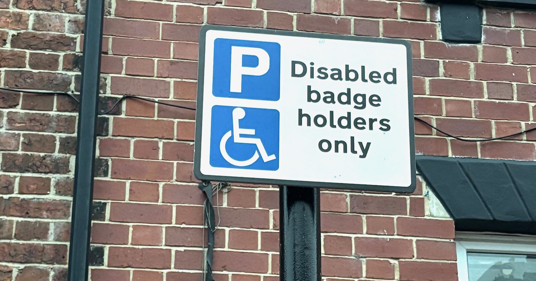 IMG_0024 A parking sign that reads: "Disabled badge holders only"