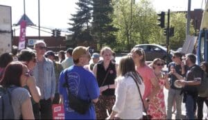 People at a protest standing and holding placards