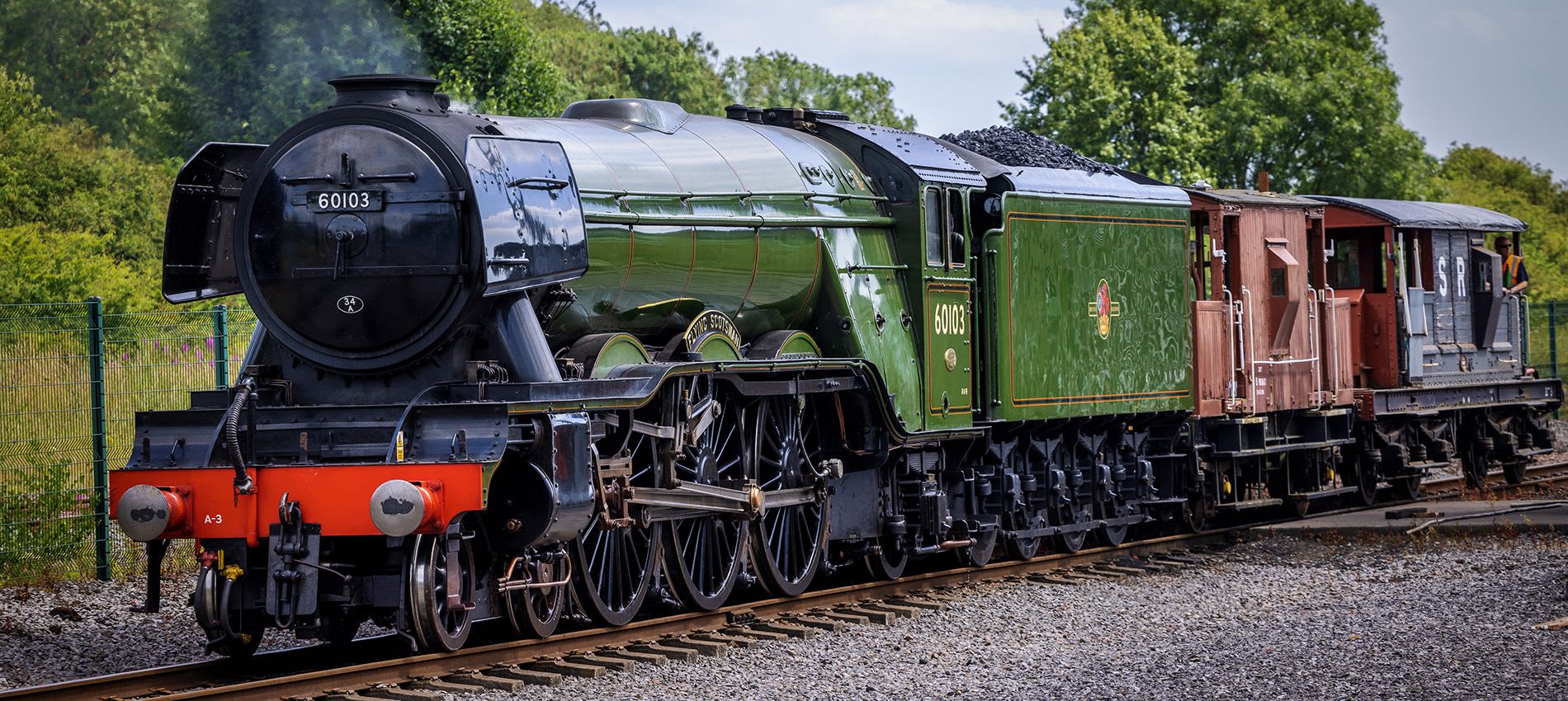 Flying Scotsman A steam locomotive going past on the tracks.
