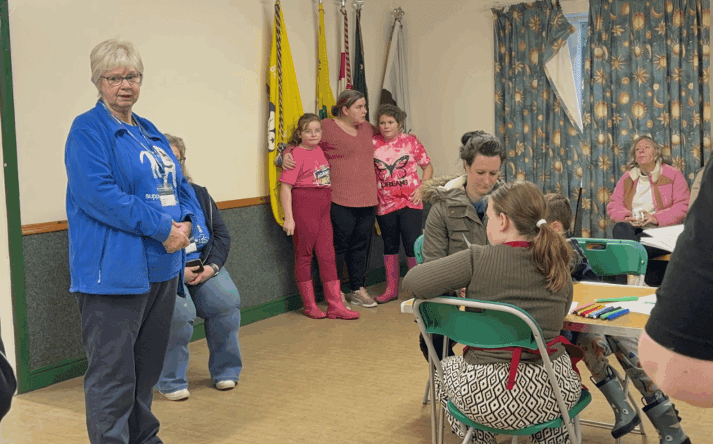 Woman in blue speaking to attendees
