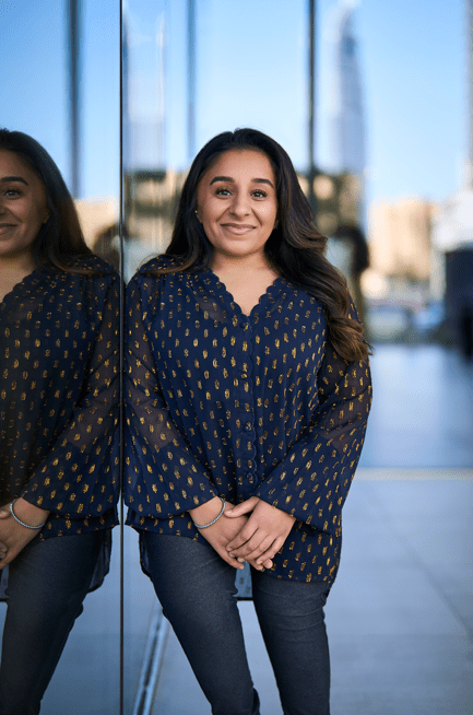 Shani Dhanda posing next to a window