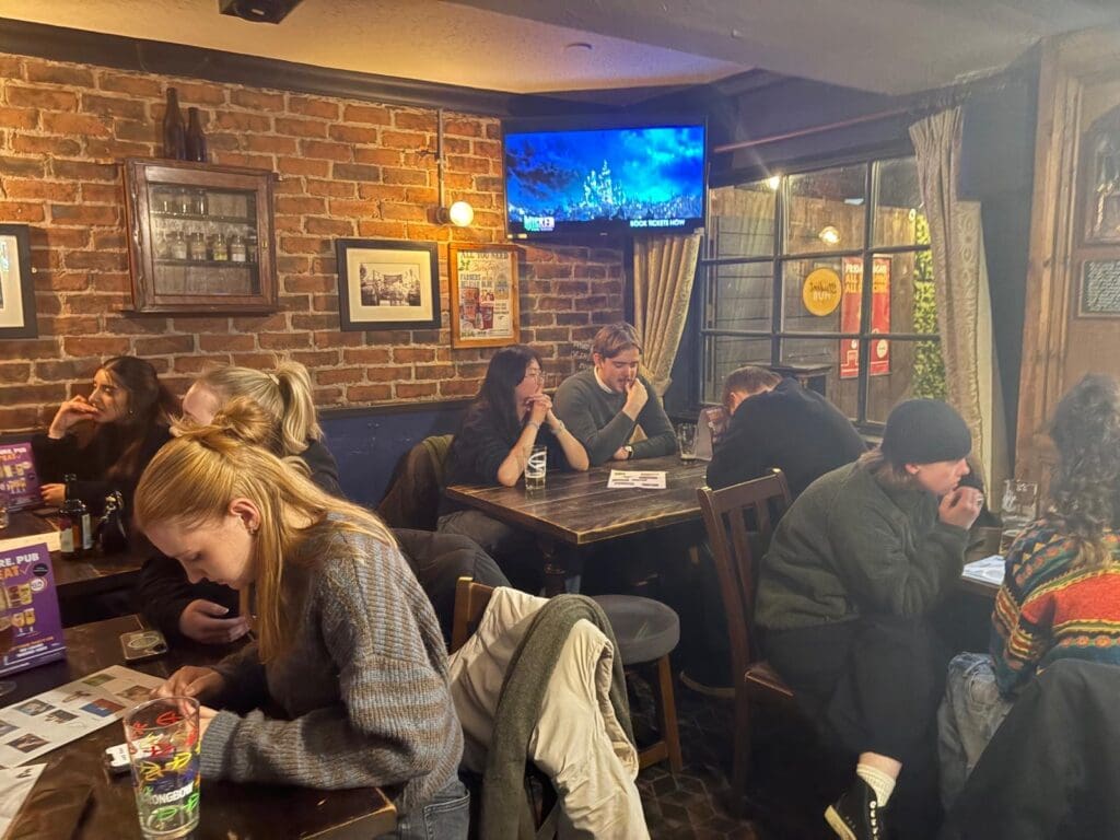 Attendees sat down at tables at a pub quiz