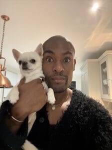 man holding a little dog