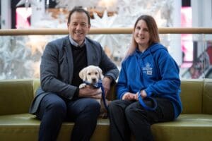 Meadowhall’s Centre Director Darren Pearce and Support Dogs’ Puppy Coordinator Emily Moss with Support Dog Meadow.