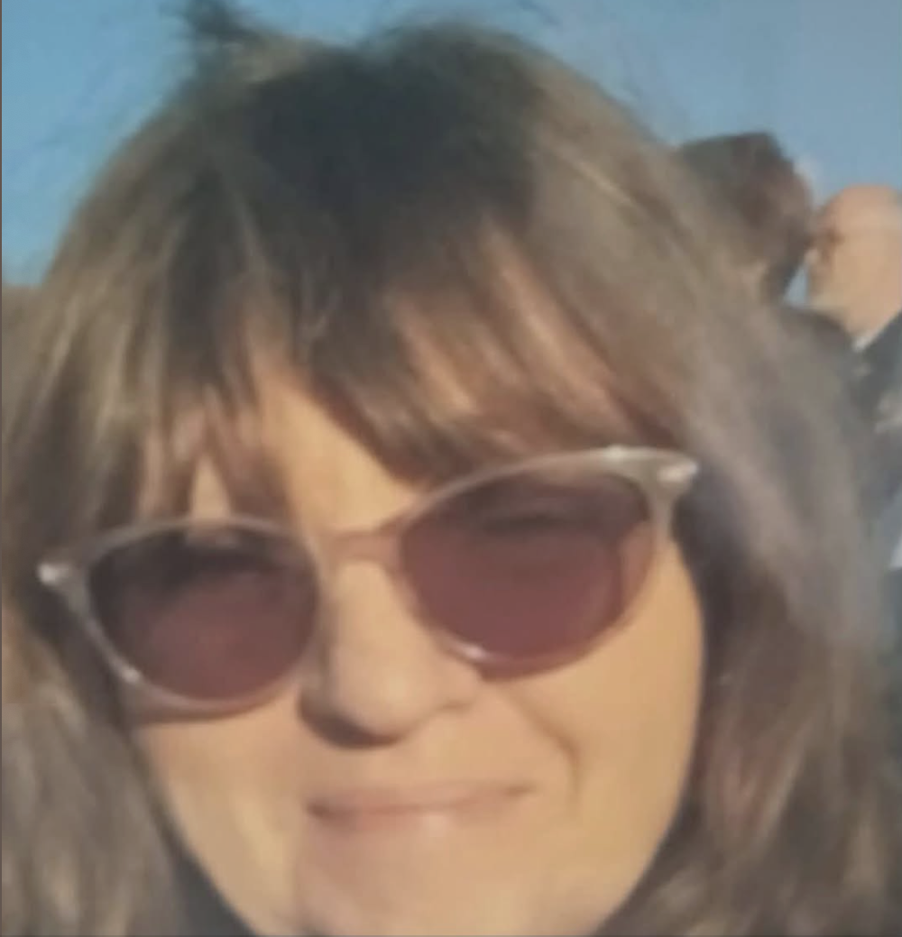 A photo of the missing, now deceased woman Dawn. She is wearing sunglasses and smiling.