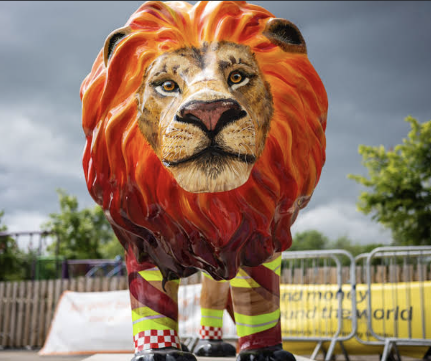 A close up of a lion sculpture, with fire-esque mane and firefighter-related design