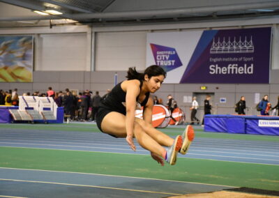 Student Jumps over some sand