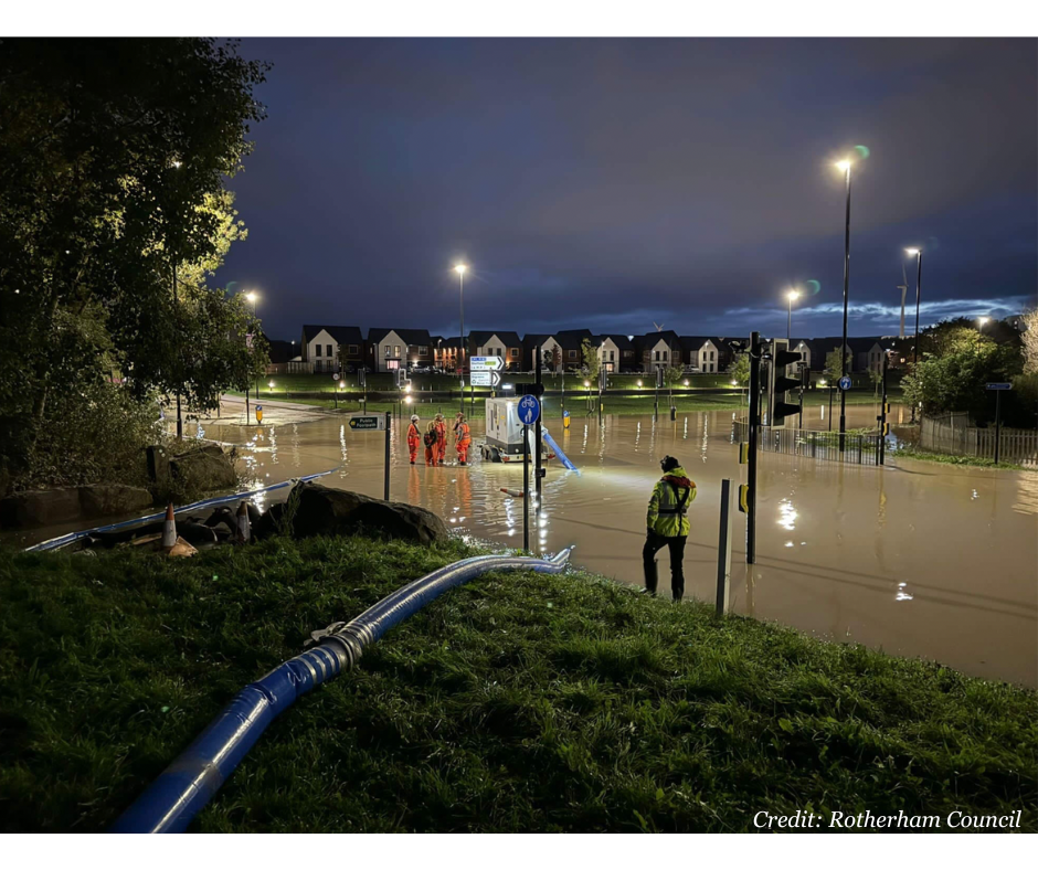 Picture of emergency response teams working to reduce water levels at night